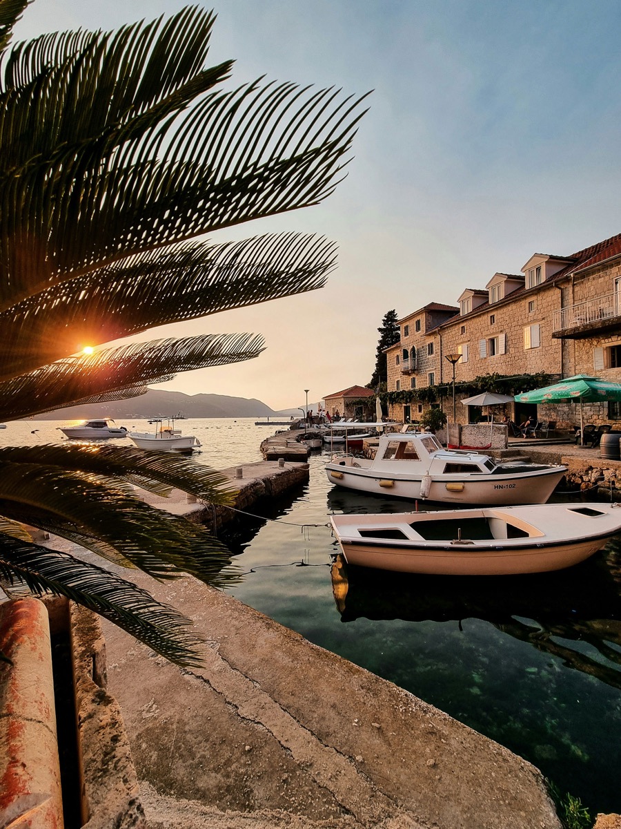 Fishing boats moored below the village at sunset