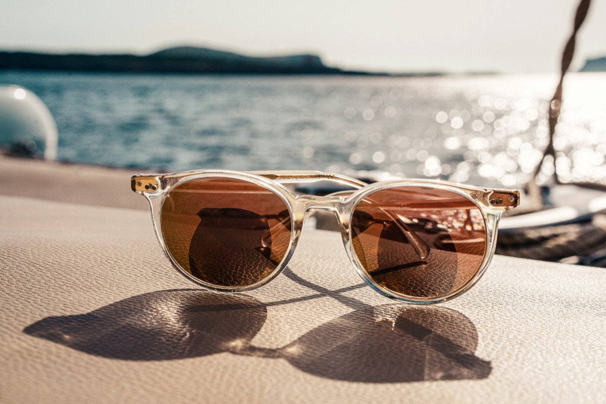 Sunglasses resting on a table, the bay beyond