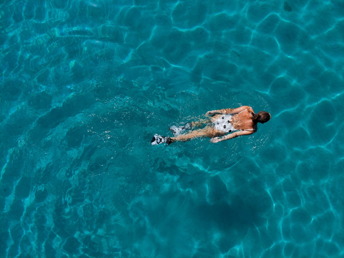 Swimming in clear turquoise water seen from above